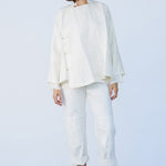 Front view of rice mandarin jacket on model wearing rice pants and natural sandals, against a white background.
