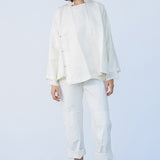 Front view of rice mandarin jacket on model wearing rice pants and natural sandals, against a white background.