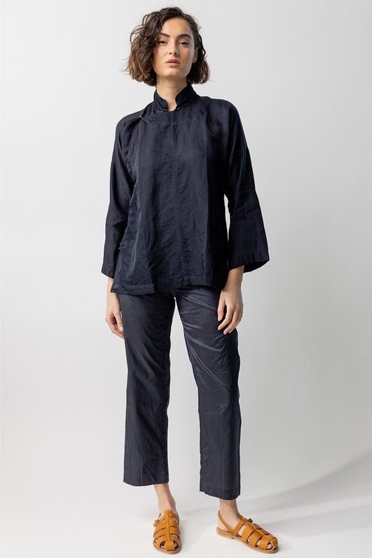 Front view of midnight mandarin jacket on model wearing midnight pants and natural sandals, against a white background.
