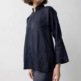 Alternate side view of midnight mandarin jacket on model wearing midnight pants, against a white background.