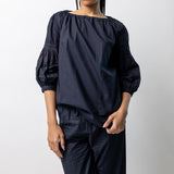 Front closeup view of midnight  mary ellen mark blouse on model wearing midnight pants, against a white background.