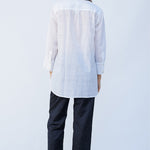 Back view of midnight pajama pant on model wearing white tunic and natural sandals, against a white background.