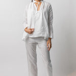 Front view of tint pajama pant on model wearing white top and natural sandals, against a white background.