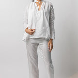 Front view of tint pajama pant on model wearing white top and natural sandals, against a white background.