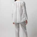 Back view of tint pajama pant on model wearing white top and natural sandals, against a white background.