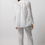 Back view of tint pajama pant on model wearing white top and natural sandals, against a white background.
