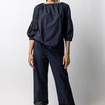 Front view of midnight pants with lace on model wearing midnight top with natural sandals, against a white background.