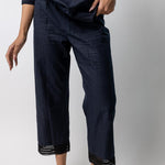 Closeup view of midnight pants with lace on model wearing midnight top and natural sandals, against a white background.
