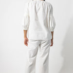 Back view of rice pants with lace on model wearing rice top, against a white background.