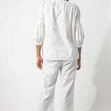 Back view of rice pants with lace on model wearing rice top, against a white background.