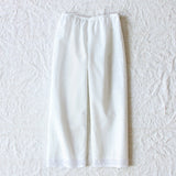 Front view of rice pants with lace on white background, with no model shown.