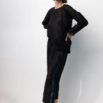 Side view of midnight pants with velvet ribbon on model wearing midnight top and natural sandals, against a white background.