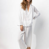 Front view of rice pants with velvet ribbon on model wearing rice top and natural sandals, against a white background.
