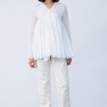Front view of rice rabari jacket on model wearing white pants and natural sandals, against a white background.