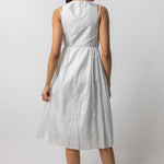 Back view of tint rajasthani dress on model wearing natural sandals, against a white background.