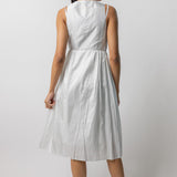 Back view of tint rajasthani dress on model wearing natural sandals, against a white background.