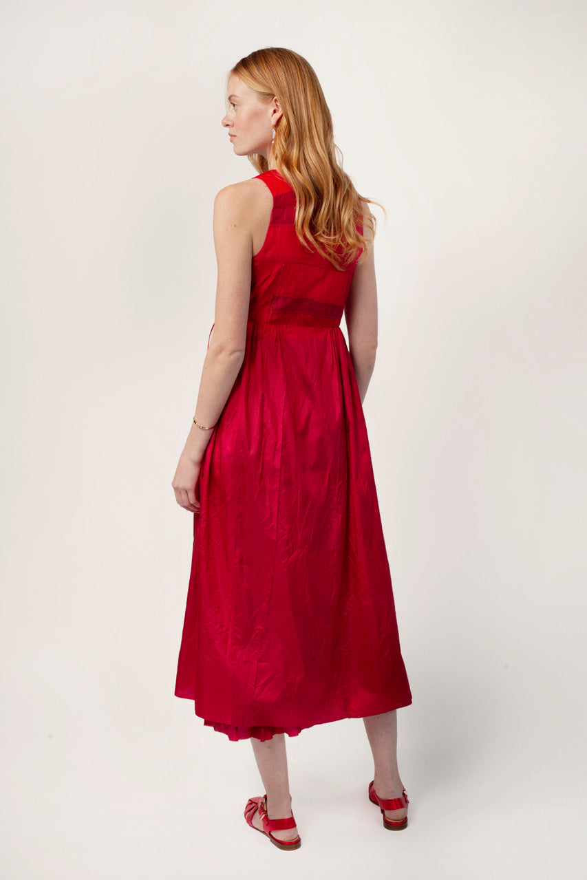 Back view of lipstick rajasthani dress on model wearing red sandals, against a white background.