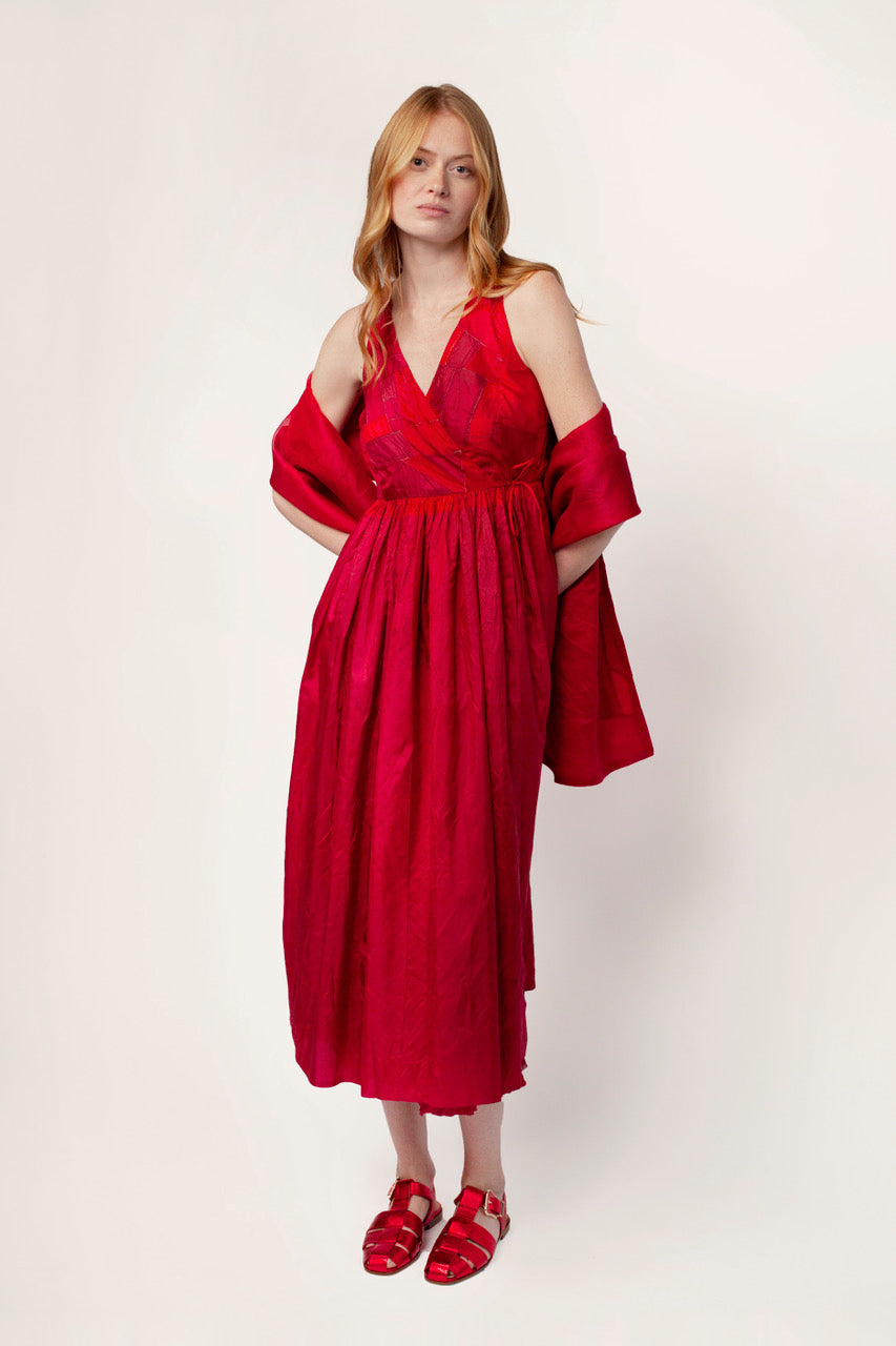 Front view of lipstick rajasthani dress with lipstick shawl and red sandals, against a white background.