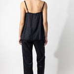 Back view of midnight short chemise on model wearing midnight pants and natural sandals, against a white background