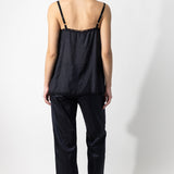Back view of midnight short chemise on model wearing midnight pants and natural sandals, against a white background