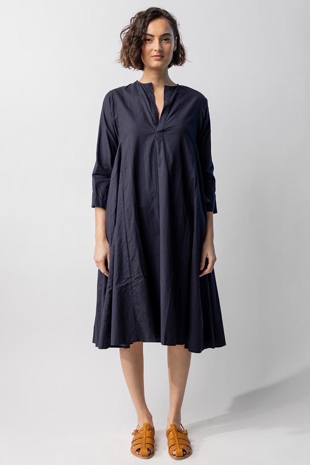 Front view of midnight short tule dress on model wearing natural sandals, against a white background.