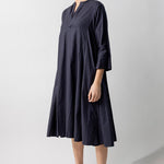 Side view of midnight short tule dress on model wearing natural sandals, against a white background.