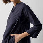 Side closeup view of midnight short tule dress on model, against a white background.