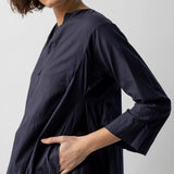 Side closeup view of midnight short tule dress on model, against a white background.