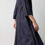 Alternate side view of midnight short tule dress on model, against a white background.