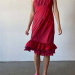 Front view of lipstick slip with ruffles on model wearing pink sneakers, against a white background.