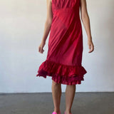 Front view of lipstick slip with ruffles on model wearing pink sneakers, against a white background.