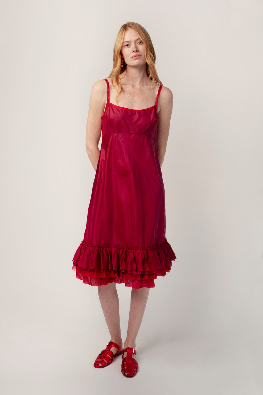 Front view of tibet dosa slip with ruffles on model wearing red sandals, against a white background
