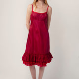 Front view of tibet dosa slip with ruffles on model wearing red sandals, against a white background