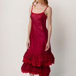 Side view of tibet slip with ruffles on model wearing extra ruffle skirt and red sandals, against a white background