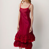 Side view of tibet slip with ruffles on model wearing extra ruffle skirt and red sandals, against a white background