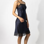 Alternate side view of midnight susan slip on model wearing natural sandals, against a white background.