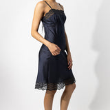 Alternate side view of midnight susan slip on model wearing natural sandals, against a white background.