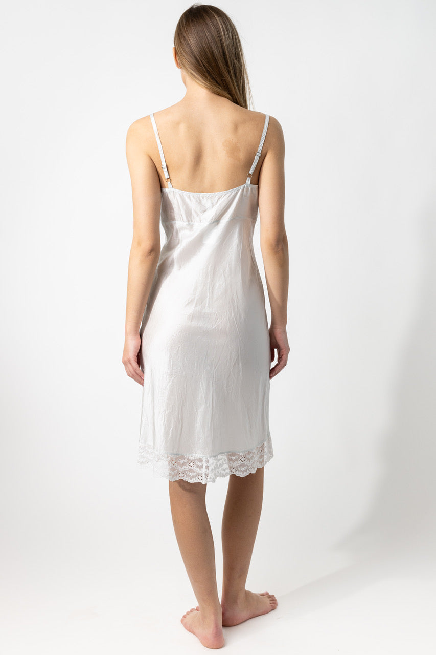 Back view of tint susan slip on model against a white background.