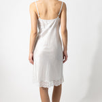 Back view of tint susan slip on model against a white background.