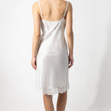 Back view of tint susan slip on model against a white background.