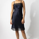 Front view of midnight susan slip on model wearing natural sandals, against a white background.