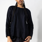 Front view of midnight tunisian top on model wearing midnight pants, against a white background.