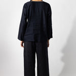 Back view of midnight tunisian top on model wearing midnight pants, against a white background.