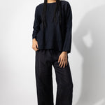 Front view of midnight wide leg pants on model wearing midnight top, against a white background.