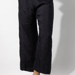 Front closeup view of midnight wide leg pants on model wearing midnight top, against a white background.