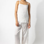 Front view of rice wide leg pants on model wearing rice top and natural sandals, against a white background.