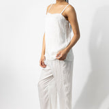 Side view of rice wide leg pants on model wearing rice top and natural sandals, against a white background.