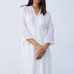 Front closeup view of rice wrap dress on model, against a white background.