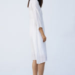 Side view of rice wrap dress on model wearing natural sandals, against a white background.