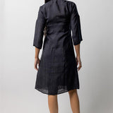 Back view of midnight wrap dress on model wearing natural sandals, against a white background.